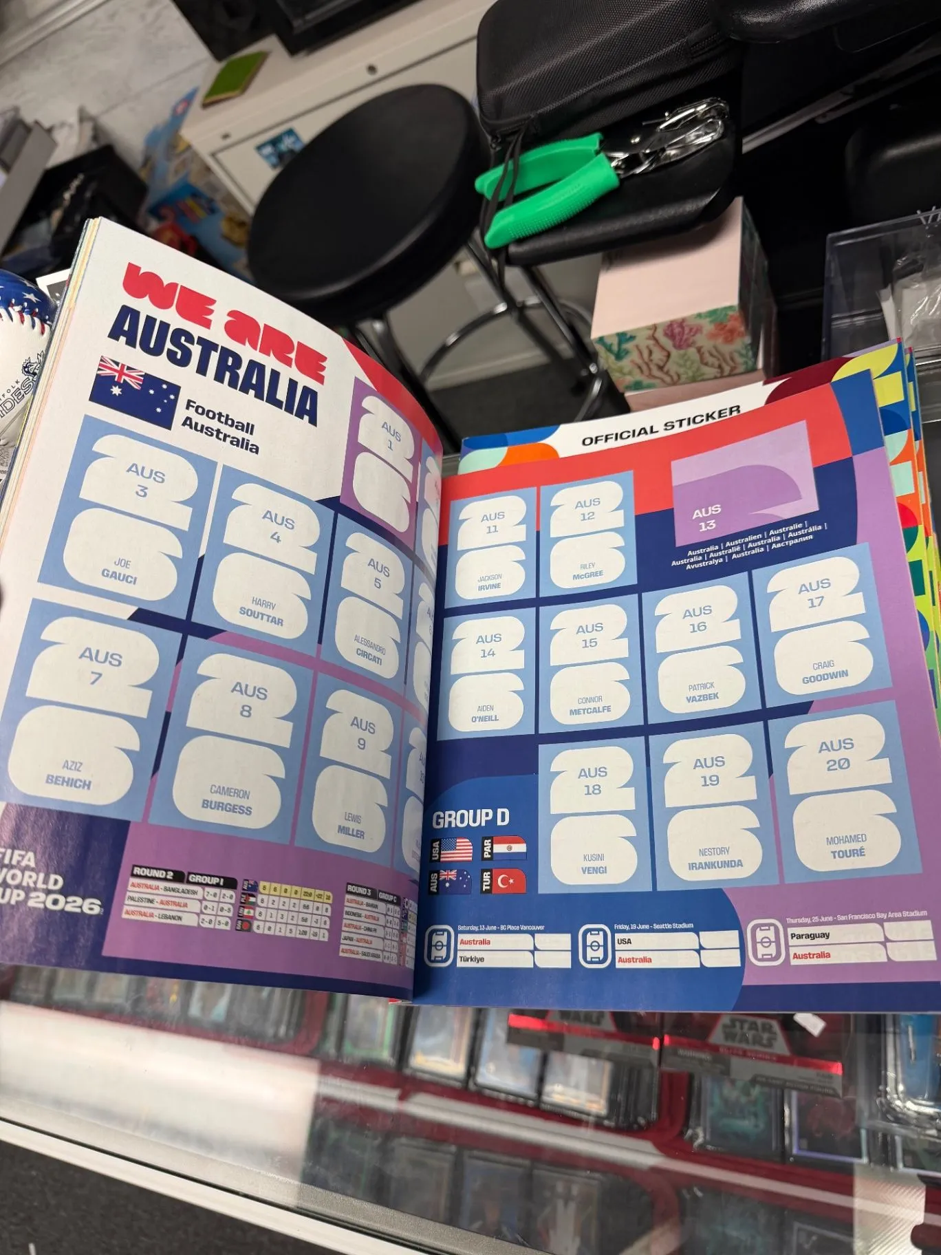 Opened FIFA World Cup sticker album on a table
